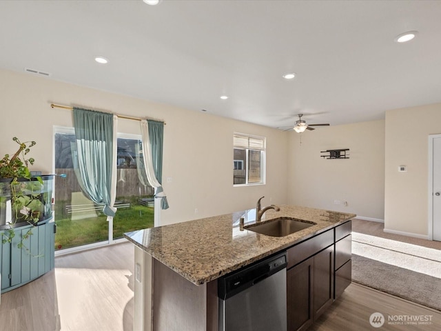 12029 317th Dr SE, Sultan, WA 98294 - kitchen featuring dishwasher, light stone counters, a ceiling fan, a center island with sink, and light wood-style floors
