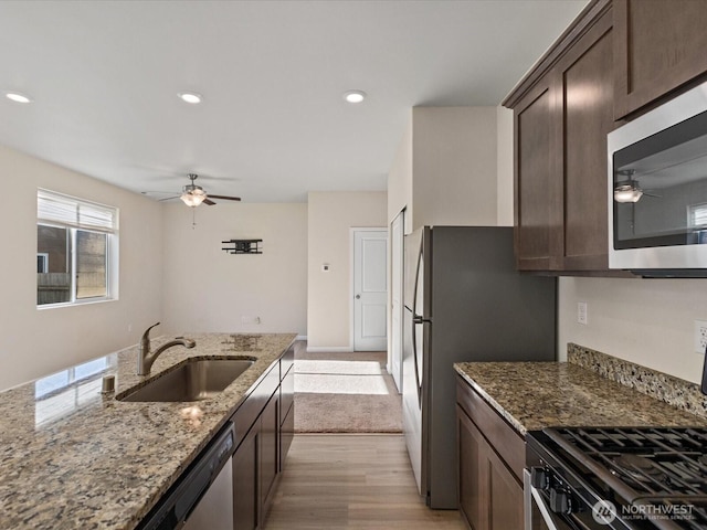 12029 317th Dr SE, Sultan, WA 98294 - kitchen with stainless steel appliances, ceiling fan, dark brown cabinets, light stone countertops, and recessed lighting