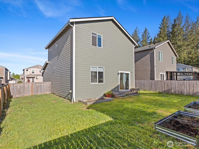12029 317th Dr SE, Sultan, WA 98294 - rear view of property with a vegetable garden and a fenced backyard