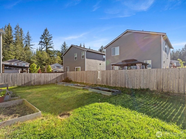12029 317th Dr SE, Sultan, WA 98294 - fenced backyard featuring a garden and a gazebo