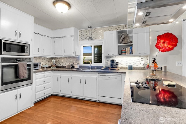 4111 164th St SW Unit 2, Lynnwood, WA 98087 - kitchen featuring appliances with stainless steel finishes, white cabinets, backsplash, and light wood-type flooring