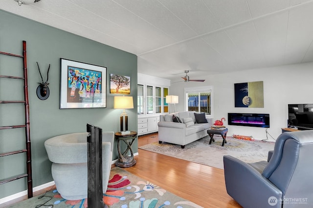 4111 164th St SW Unit 2, Lynnwood, WA 98087 - living area with wood finished floors, a ceiling fan, and a glass covered fireplace