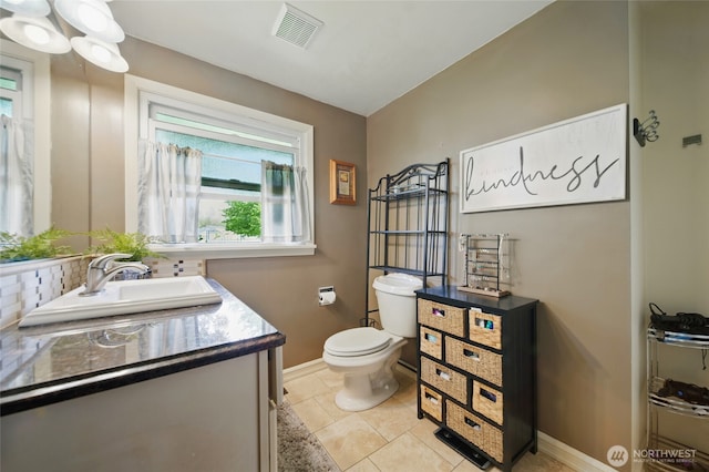 half bath featuring baseboards, vanity, toilet, decorative backsplash, and tile patterned floors
