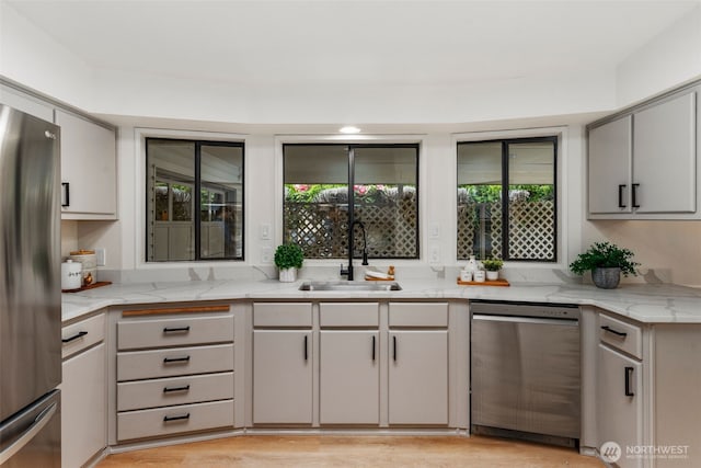 32820 20th Ave S Unit 47, Federal Way, WA 98003 - kitchen with appliances with stainless steel finishes, a sink, light stone counters, gray cabinets, and light wood-style floors