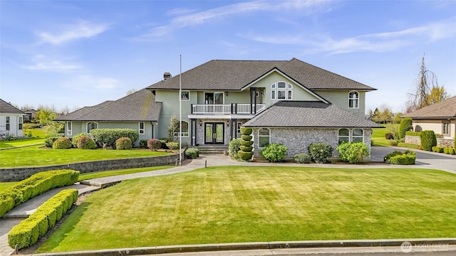 325 Island Green Way, Lynden, WA 98264 - view of front of property featuring a balcony, french doors, a front yard, stone siding, and stucco siding