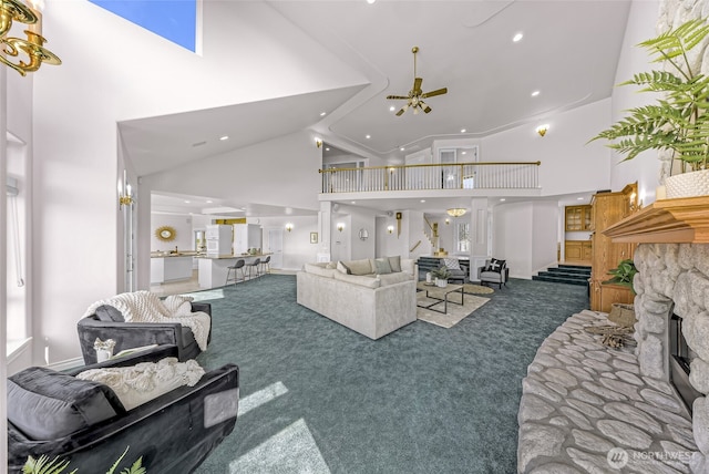 325 Island Green Way, Lynden, WA 98264 - carpeted living area with high vaulted ceiling, ceiling fan, recessed lighting, and a stone fireplace