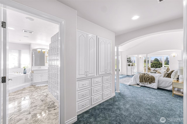 325 Island Green Way, Lynden, WA 98264 - carpeted bedroom featuring arched walkways, connected bathroom, recessed lighting, a chandelier, and ornate columns