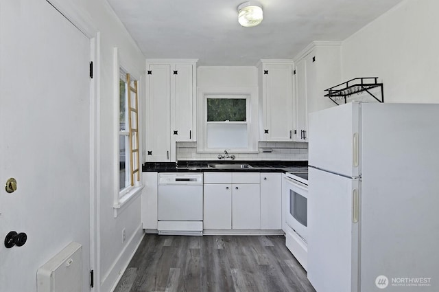 kitchen with white appliances, white cabinets, dark countertops, a sink, and dark wood-type flooring