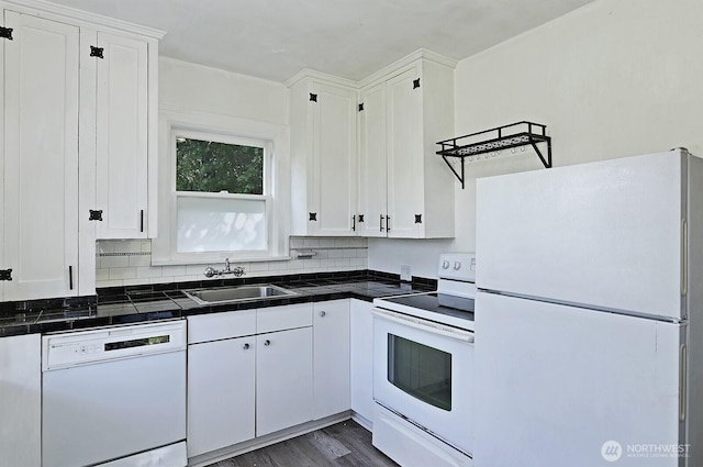 kitchen featuring white appliances, a sink, white cabinets, dark wood-style floors, and tasteful backsplash