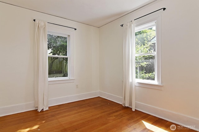 empty room with light wood-style floors and baseboards