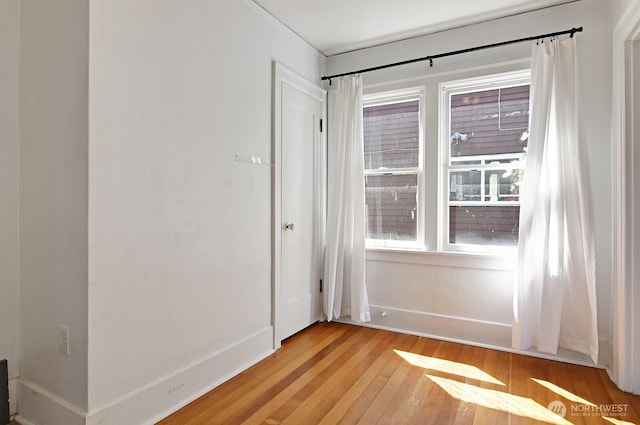 entryway with light wood finished floors and baseboards