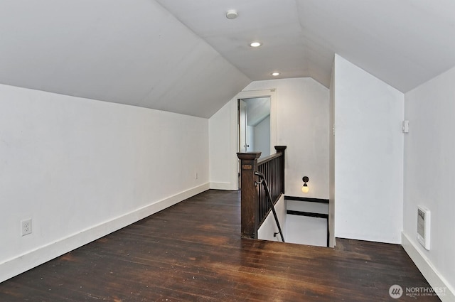 additional living space featuring wood-type flooring, vaulted ceiling, baseboards, and recessed lighting