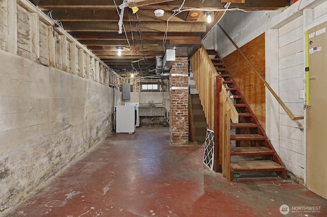 unfinished basement with washer / clothes dryer, electric panel, and stairs