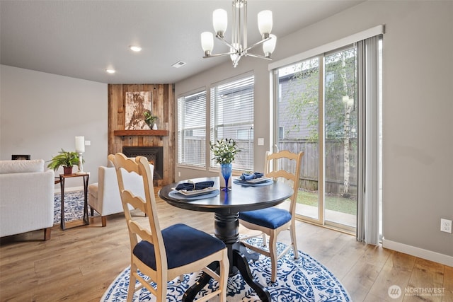 12313 NE 116th St N, Vancouver, WA 98682 - dining space with healthy amount of natural light, a chandelier, light wood-style flooring, a large fireplace, and recessed lighting