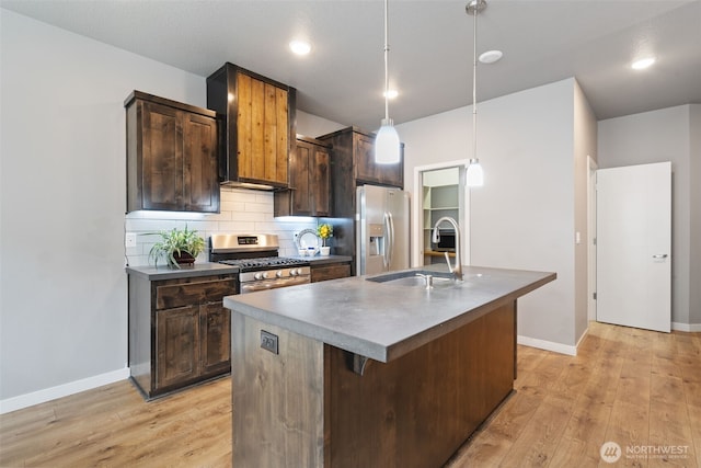 12313 NE 116th St N, Vancouver, WA 98682 - kitchen with a sink, appliances with stainless steel finishes, light wood-style flooring, tasteful backsplash, and an island with sink