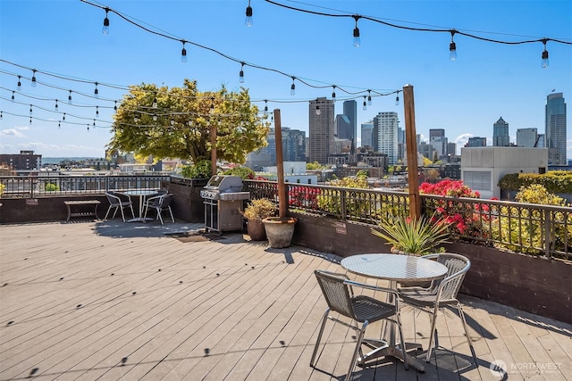 1125 E Olive St Unit 501, Seattle, WA 98122 - deck with a view of skyline, outdoor dining space, and a grill