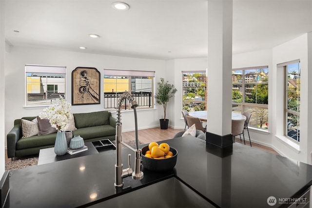 1125 E Olive St Unit 501, Seattle, WA 98122 - living room featuring wood finished floors, recessed lighting, and baseboards