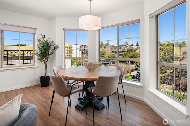 1125 E Olive St Unit 501, Seattle, WA 98122 - dining space featuring wood finished floors and baseboards