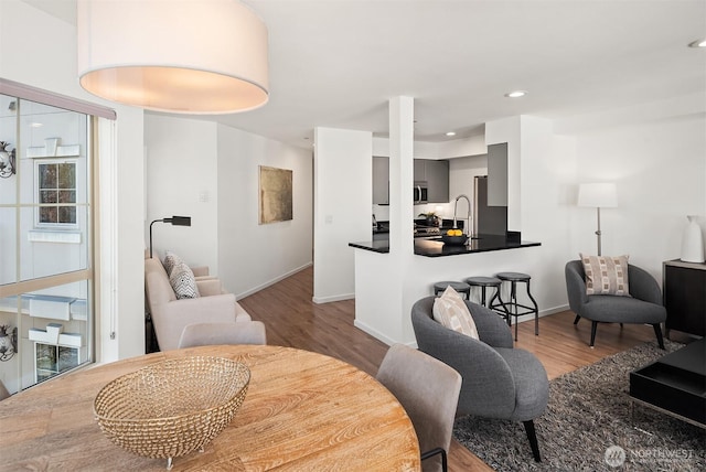 1125 E Olive St Unit 501, Seattle, WA 98122 - living area featuring wood finished floors, baseboards, and recessed lighting