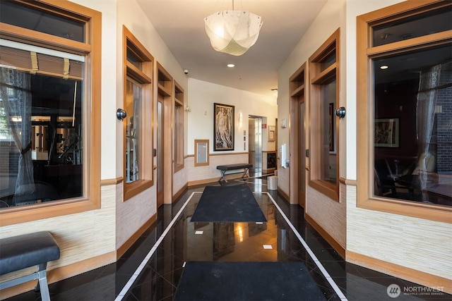 1125 E Olive St Unit 501, Seattle, WA 98122 - hall featuring granite floors, baseboards, built in features, and inlaid floor details
