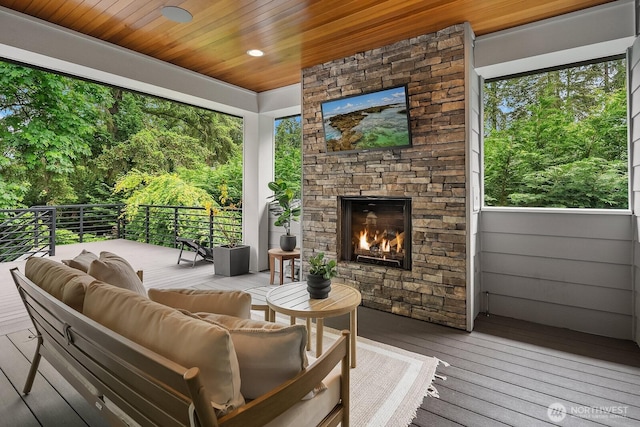 wooden terrace featuring an outdoor living space with a fireplace