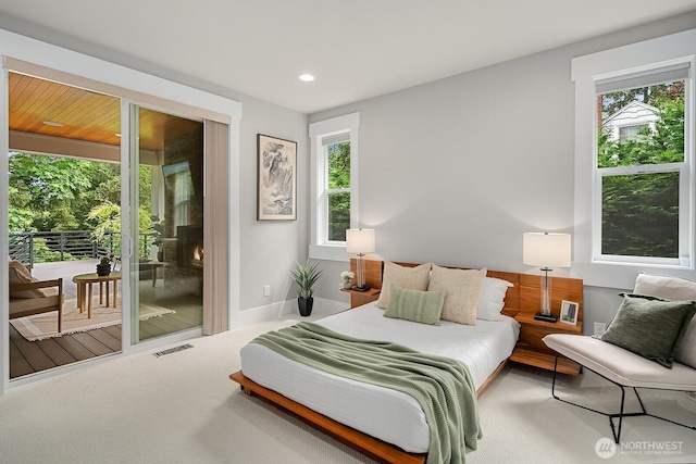 bedroom with access to outside, recessed lighting, and carpet flooring