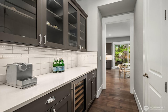 bar featuring wine cooler, dark wood-style floors, backsplash, baseboards, and recessed lighting
