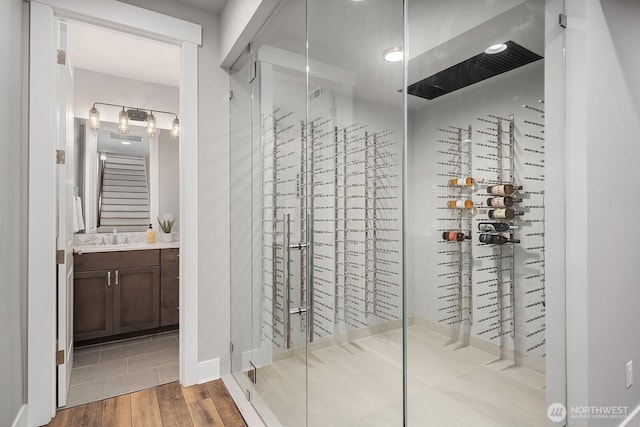 wine cellar with wood finished floors and a sink