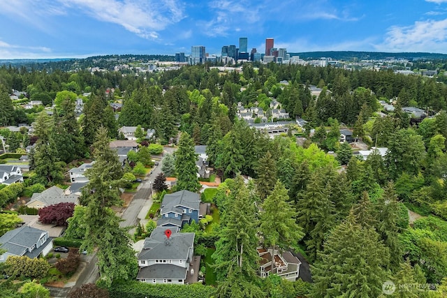 aerial view of property and surrounding area featuring nearby suburban area