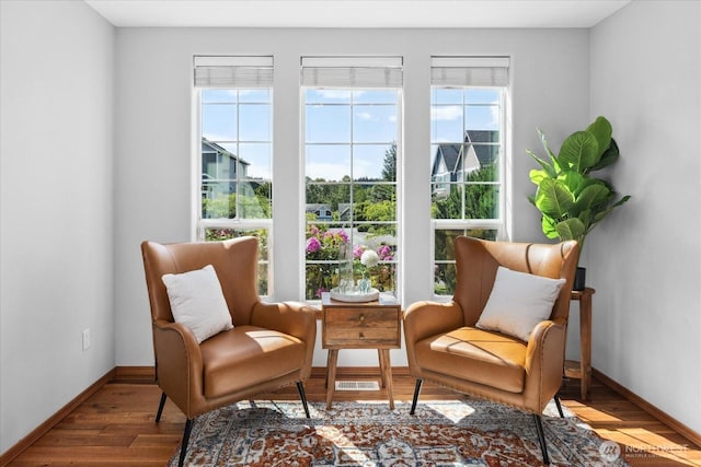 living area featuring wood finished floors and baseboards