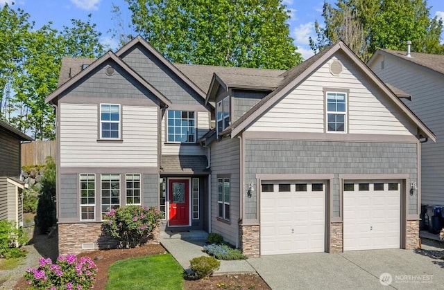 view of front of property with stone siding, driveway, and a garage