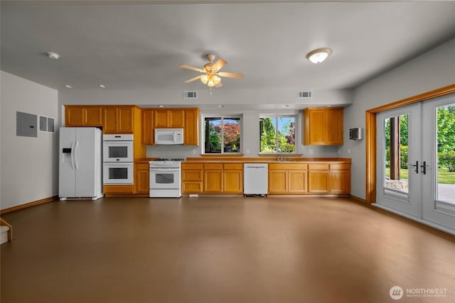 26901 15th Ave NE, Arlington, WA 98223 - kitchen with white appliances, ceiling fan, light countertops, brown cabinetry, and concrete floors