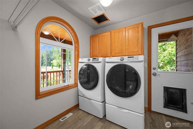 26901 15th Ave NE, Arlington, WA 98223 - laundry area with separate washer and dryer, plenty of natural light, cabinet space, and light wood-style flooring