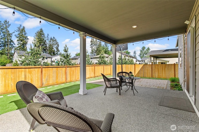 view of patio featuring a fenced backyard, a residential view, and outdoor dining area