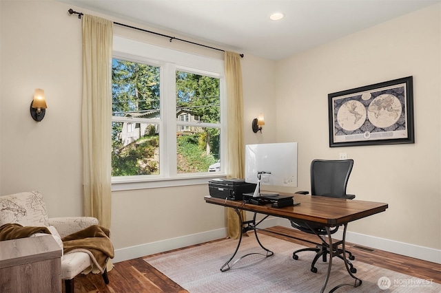 office area featuring baseboards and wood finished floors