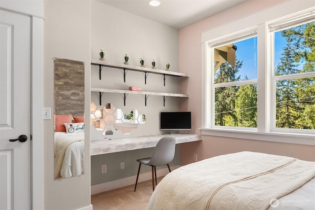 bedroom featuring carpet and baseboards