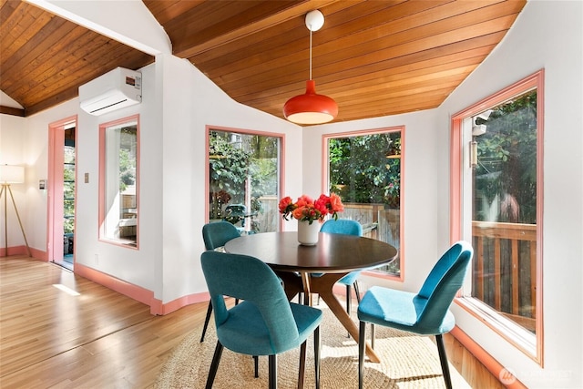 dining area featuring an AC wall unit, vaulted ceiling, wooden ceiling, baseboards, and light wood-style floors