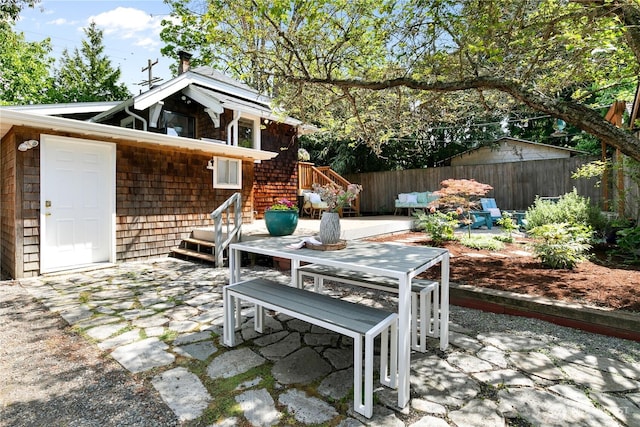 view of patio with fence and outdoor dining space