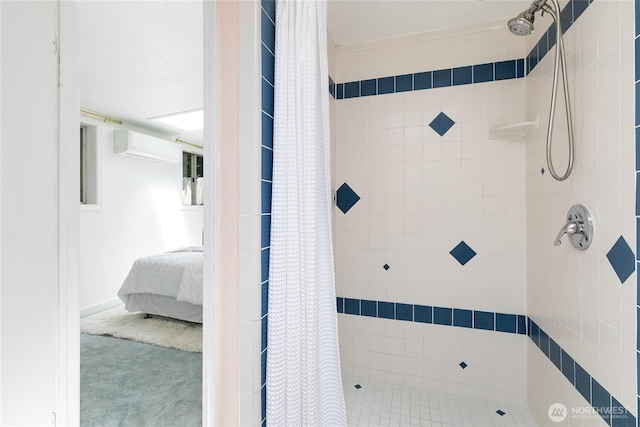ensuite bathroom featuring an AC wall unit and a tile shower