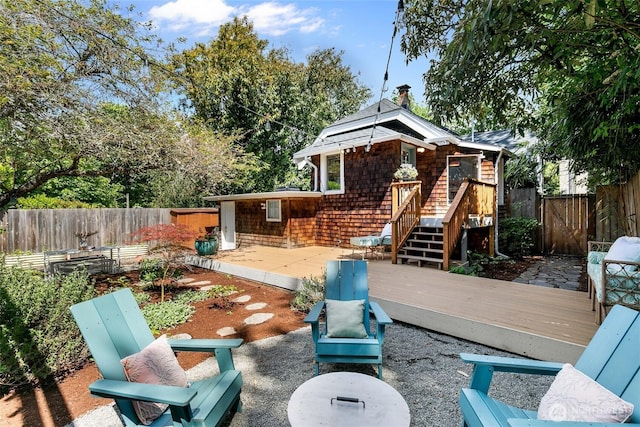 view of patio featuring a fenced backyard and a deck
