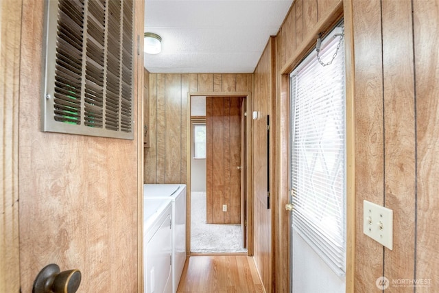 5705 113th Ave E Unit 68, Puyallup, WA 98372 - laundry room featuring washing machine and clothes dryer, wood walls, and wood finished floors