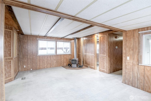5705 113th Ave E Unit 68, Puyallup, WA 98372 - carpeted spare room featuring a wood stove and wooden walls