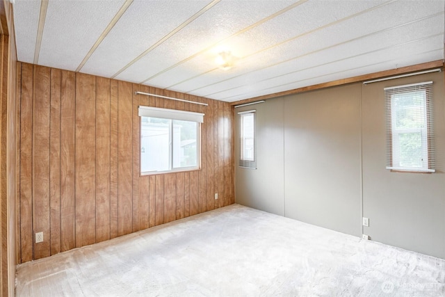 5705 113th Ave E Unit 68, Puyallup, WA 98372 - unfurnished room with healthy amount of natural light, wood walls, carpet floors, and a textured ceiling