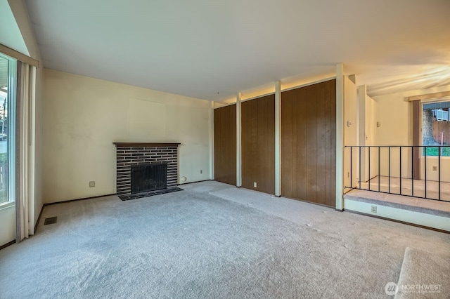 23238 21st Ave S, Des Moines, WA 98198 - unfurnished living room with light carpet and a brick fireplace
