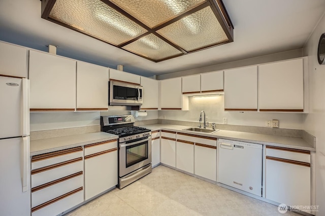 23238 21st Ave S, Des Moines, WA 98198 - kitchen featuring stainless steel appliances, a sink, light countertops, and white cabinetry