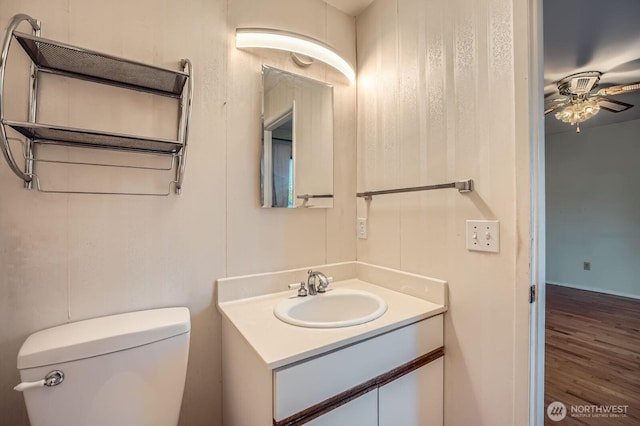 23238 21st Ave S, Des Moines, WA 98198 - bathroom featuring a ceiling fan, toilet, vanity, and wood finished floors