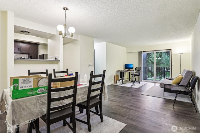 14650 NE 32nd St Unit A14, Bellevue, WA 98007 - dining area with a textured ceiling, dark wood-style flooring, and a chandelier