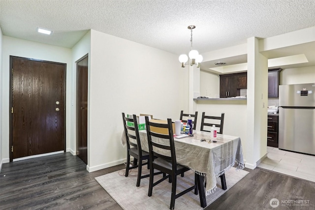 14650 NE 32nd St Unit A14, Bellevue, WA 98007 - dining room with a chandelier, wood finished floors, a textured ceiling, and baseboards