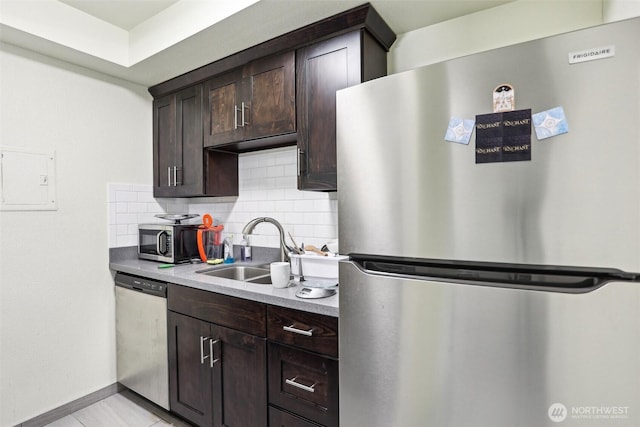 14650 NE 32nd St Unit A14, Bellevue, WA 98007 - kitchen featuring appliances with stainless steel finishes, a sink, tasteful backsplash, dark brown cabinets, and baseboards