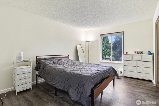 14650 NE 32nd St Unit A14, Bellevue, WA 98007 - bedroom featuring a textured ceiling and dark wood finished floors
